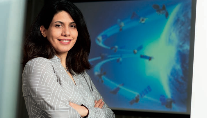 Dr. Leila Farhadi leaning against wall