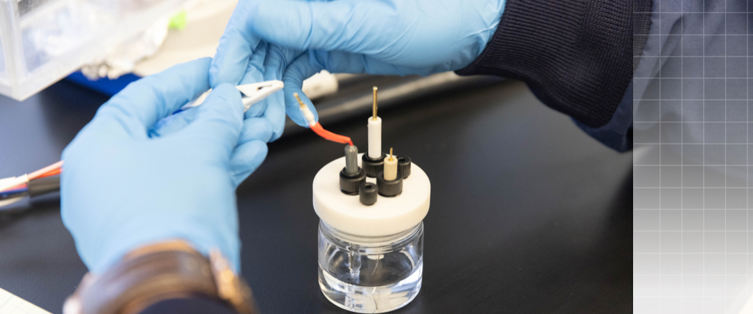close up of researcher's hand working on device