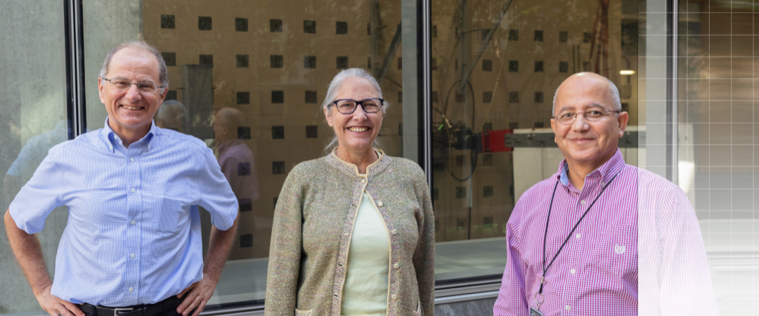 Professors Silva, Roddis, and Badie smiling and posing in front of the highbay