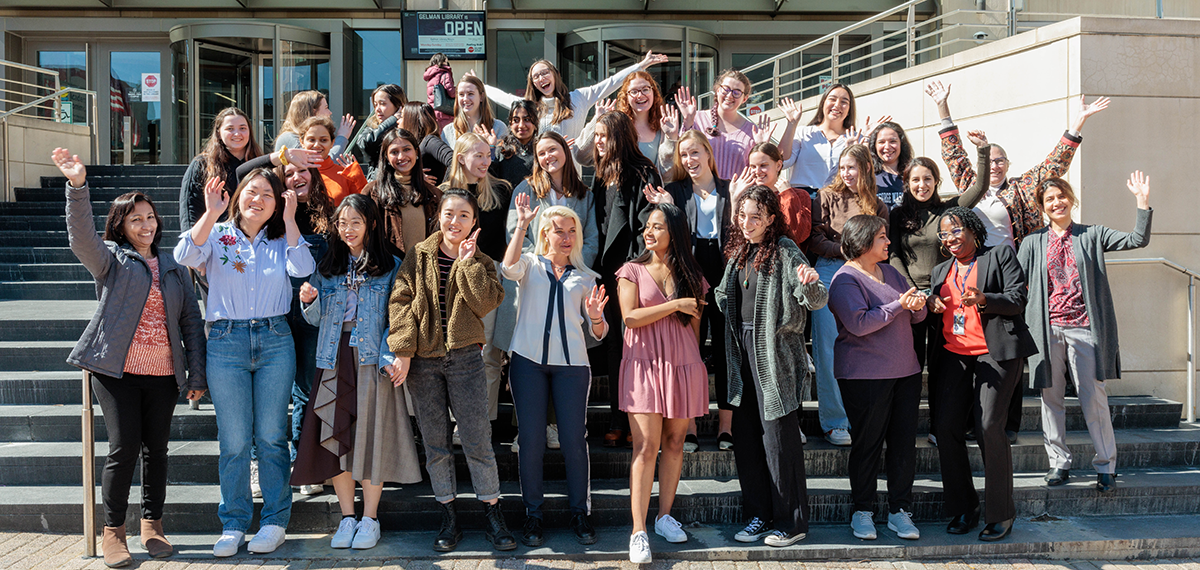 group of women students and faculty standing on the steps
