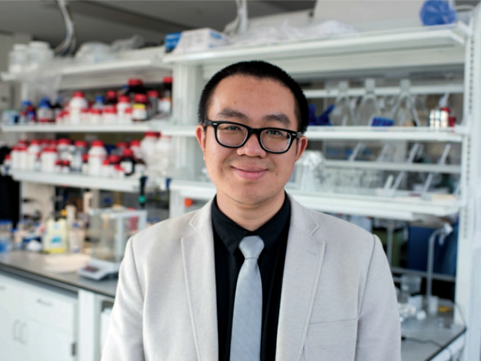 Prof. Danmeng Shuai standing in front of lab bench