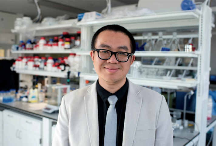 Prof. Danmeng Shuai standing in front of lab bench