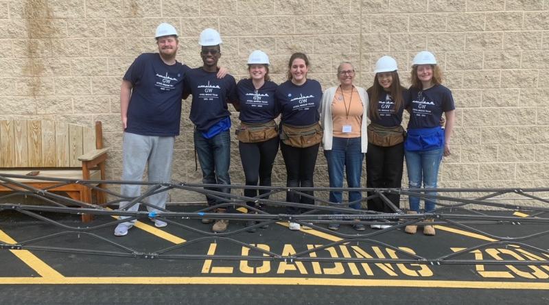 steel bridge team posing with Professor Roddis in front of bridge design