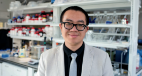Prof. Danmeng Shuai standing in front of lab bench
